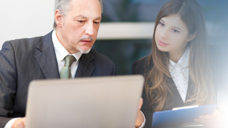 business man and woman reviewing resumes for job interviews