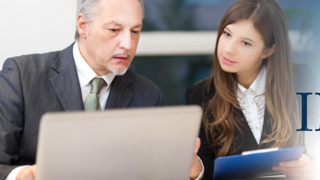 business man and woman reviewing resumes for job interviews